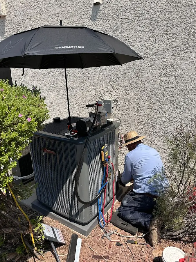 HVAC technician performing outdoor AC maintenance in Moss Bluff
